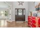 Entryway with hardwood floors, a decorative front door, and a stylish red accent chest at 1003 Burnt Hickory Ct, Apex, NC 27502