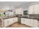 Well-equipped kitchen featuring white cabinets, sleek countertops, and stainless steel appliances at 1003 Burnt Hickory Ct, Apex, NC 27502