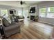 Spacious living room with wood floors, fireplace, and lots of natural light from multiple windows at 1003 Burnt Hickory Ct, Apex, NC 27502