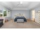 Spacious primary bedroom with a tray ceiling and large windows at 1003 Burnt Hickory Ct, Apex, NC 27502