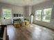 Bright sitting room boasts ample natural light, complemented by modern furniture and wood floors at 1003 Burnt Hickory Ct, Apex, NC 27502