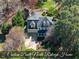 Stunning aerial view of the custom-built home featuring a manicured lawn, stone seating area, and mature landscaping at 1006 Henny Pl, Raleigh, NC 27614