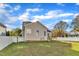 A well-manicured lawn in the backyard with a cozy deck and home exterior at 10603 Friendly Neighbor Ln, Raleigh, NC 27614