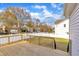 A wood backyard deck with a white fence in a residential neighborhood on a sunny day at 10603 Friendly Neighbor Ln, Raleigh, NC 27614