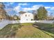 Backyard with a spacious lawn and a white fence surrounding the property at 10603 Friendly Neighbor Ln, Raleigh, NC 27614