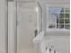 Bathroom with a frosted-glass shower and a view through the window at 10603 Friendly Neighbor Ln, Raleigh, NC 27614