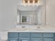 Bathroom with a double sink vanity, a white countertop, and a large mirror at 10603 Friendly Neighbor Ln, Raleigh, NC 27614