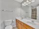Well-lit bathroom with double sinks, a large mirror, and a shower/tub combination at 10603 Friendly Neighbor Ln, Raleigh, NC 27614