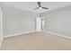 Large bedroom with ceiling fan and view through doorway, offering a comfortable space at 10603 Friendly Neighbor Ln, Raleigh, NC 27614