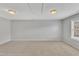 Large bedroom features neutral carpet, two flush mount lights, and attic access on ceiling at 10603 Friendly Neighbor Ln, Raleigh, NC 27614