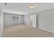 Spacious bedroom with neutral carpet, recessed lighting, and natural light from the window at 10603 Friendly Neighbor Ln, Raleigh, NC 27614