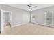 Light-filled bedroom with ceiling fan and large windows, perfect for a restful retreat at 10603 Friendly Neighbor Ln, Raleigh, NC 27614