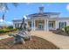 Clubhouse exterior with statue and landscaping, showcasing covered entrance, and architectural details at 10603 Friendly Neighbor Ln, Raleigh, NC 27614
