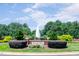Beautiful Bedford community entrance sign with brickwork, lush landscaping, and a central water fountain feature at 10603 Friendly Neighbor Ln, Raleigh, NC 27614