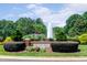 A scenic view of the Bedford community entrance showcasing beautiful landscaping and a tiered fountain at 10603 Friendly Neighbor Ln, Raleigh, NC 27614