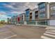 Contemporary apartment complex featuring retail space and restaurant dining with second story balconies at 10603 Friendly Neighbor Ln, Raleigh, NC 27614