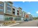 Modern apartment complex featuring retail shopping and dining on the ground floor and second story balconies at 10603 Friendly Neighbor Ln, Raleigh, NC 27614