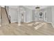 Bright foyer boasts wood floors, staircase, and a chandelier, creating an inviting entryway at 10603 Friendly Neighbor Ln, Raleigh, NC 27614