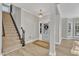 Inviting foyer with staircase, decorative lighting, and wood-look flooring at 10603 Friendly Neighbor Ln, Raleigh, NC 27614