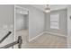 Well-lit hallway with view into bedroom, featuring neutral carpet and modern light fixture at 10603 Friendly Neighbor Ln, Raleigh, NC 27614