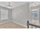 Upstairs hallway with a chandelier and neutral color palette leads to well-lit bedrooms at 10603 Friendly Neighbor Ln, Raleigh, NC 27614