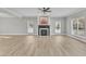 Bright living room boasting a fireplace, ceiling fan, and large windows for natural light at 10603 Friendly Neighbor Ln, Raleigh, NC 27614