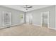Bright main bedroom with ceiling fan, closet, and large windows offering natural light at 10603 Friendly Neighbor Ln, Raleigh, NC 27614