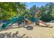 Community playground with a variety of slides and climbing equipment for entertainment at 10603 Friendly Neighbor Ln, Raleigh, NC 27614