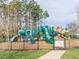 Fenced in Community playground with slides and climbing equipment for entertainment at 10603 Friendly Neighbor Ln, Raleigh, NC 27614