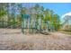 Community playground featuring slides and climbing equipment on a wood chip surface at 10603 Friendly Neighbor Ln, Raleigh, NC 27614