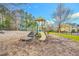Community playground featuring slides, climbing equipment, and a soft, cushioned ground for safety and enjoyment at 10603 Friendly Neighbor Ln, Raleigh, NC 27614