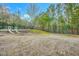 Community playground swings and slides on a wood chip surface surrounded by trees at 10603 Friendly Neighbor Ln, Raleigh, NC 27614