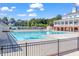 Spacious community pool area featuring a clubhouse, pergola, and mature trees at 10603 Friendly Neighbor Ln, Raleigh, NC 27614