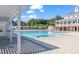 Large community pool with covered pergola and view of the clubhouse on a bright, sunny day at 10603 Friendly Neighbor Ln, Raleigh, NC 27614