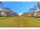 Long green Bedford community space bordered by sidewalks, mature trees, street lamps, and attractive homes at 10603 Friendly Neighbor Ln, Raleigh, NC 27614