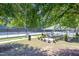 Inviting community tennis courts and shaded picnic area with landscaping on a sunny day at 10603 Friendly Neighbor Ln, Raleigh, NC 27614