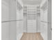 Walk-in closet with white shelving, drawers, and ample hanging space at 10603 Friendly Neighbor Ln, Raleigh, NC 27614
