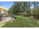 Expansive backyard with lush green lawn, mature trees, and a patio area, ideal for outdoor activities and gatherings at 107 Trackimire Ln, Apex, NC 27539