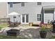 Inviting backyard patio with outdoor seating, a grill, and a fire pit, creating a cozy and functional outdoor living area at 107 Trackimire Ln, Apex, NC 27539