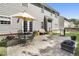Spacious backyard patio featuring outdoor seating, a grill, and an umbrella, perfect for relaxing or entertaining guests at 107 Trackimire Ln, Apex, NC 27539