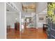 Bright foyer featuring gleaming hardwood floors, a staircase, and an open floor plan at 107 Trackimire Ln, Apex, NC 27539