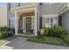 Charming entryway with a decorated front door, brick accents, and manicured landscaping at 107 Trackimire Ln, Apex, NC 27539