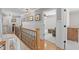 Second floor hallway with hardwood floors leading into the living area and a bedroom at 107 Trackimire Ln, Apex, NC 27539