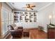 Cozy sitting area with built-in bookshelves, hardwood floors, and neutral paint at 107 Trackimire Ln, Apex, NC 27539