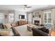 Inviting living room with fireplace, plush seating, ceiling fan, and TV console with convenient window light at 107 Trackimire Ln, Apex, NC 27539