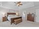 Spacious main bedroom with a tray ceiling, king bed, and ensuite bathroom access at 107 Trackimire Ln, Apex, NC 27539