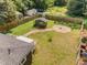 Aerial view of a large yard with a shed, fire pit, and green grass at 109 St Marys St, Garner, NC 27529