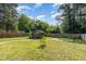 Landscaped backyard featuring a shed, green grass, and a wood fence at 109 St Marys St, Garner, NC 27529