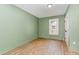 This is a bedroom with hardwood floors, light green walls, and a window at 109 St Marys St, Garner, NC 27529