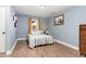 Cozy bedroom with wood-look floors, blue walls, and a bright window at 109 St Marys St, Garner, NC 27529